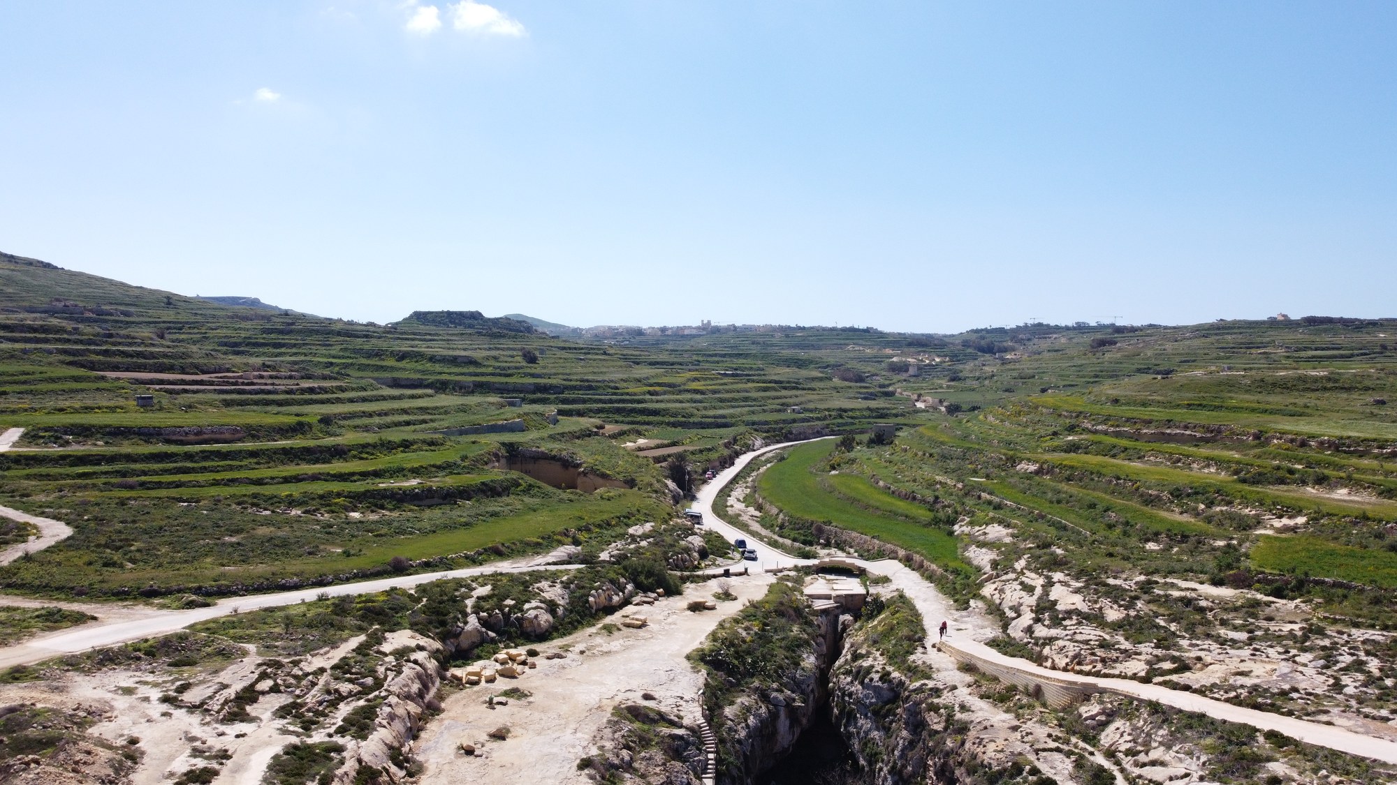 Aerial view across Gozo's green terraced fields and winding rural roads
