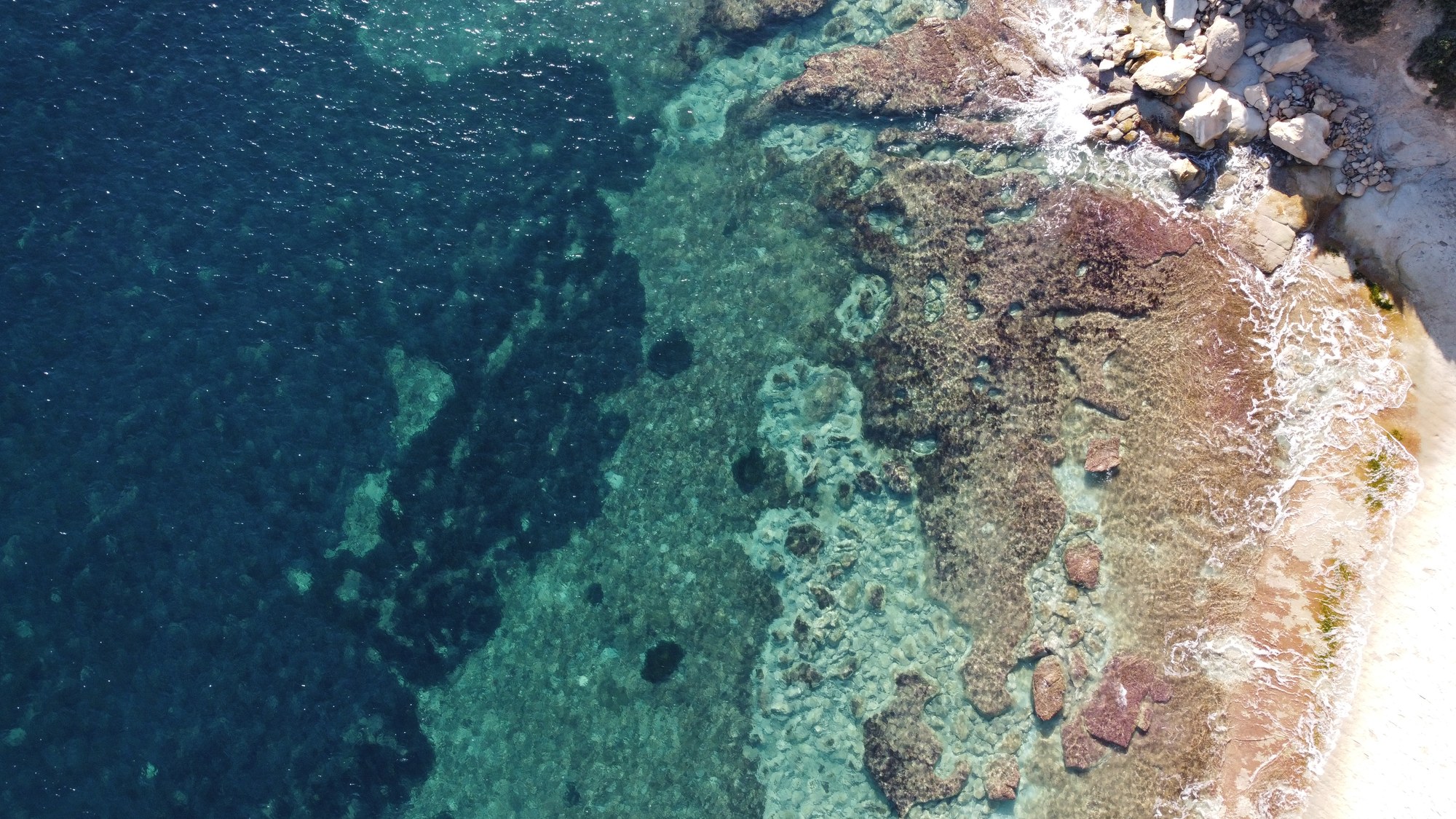 Clear Mediterranean water revealing the shallow reef below