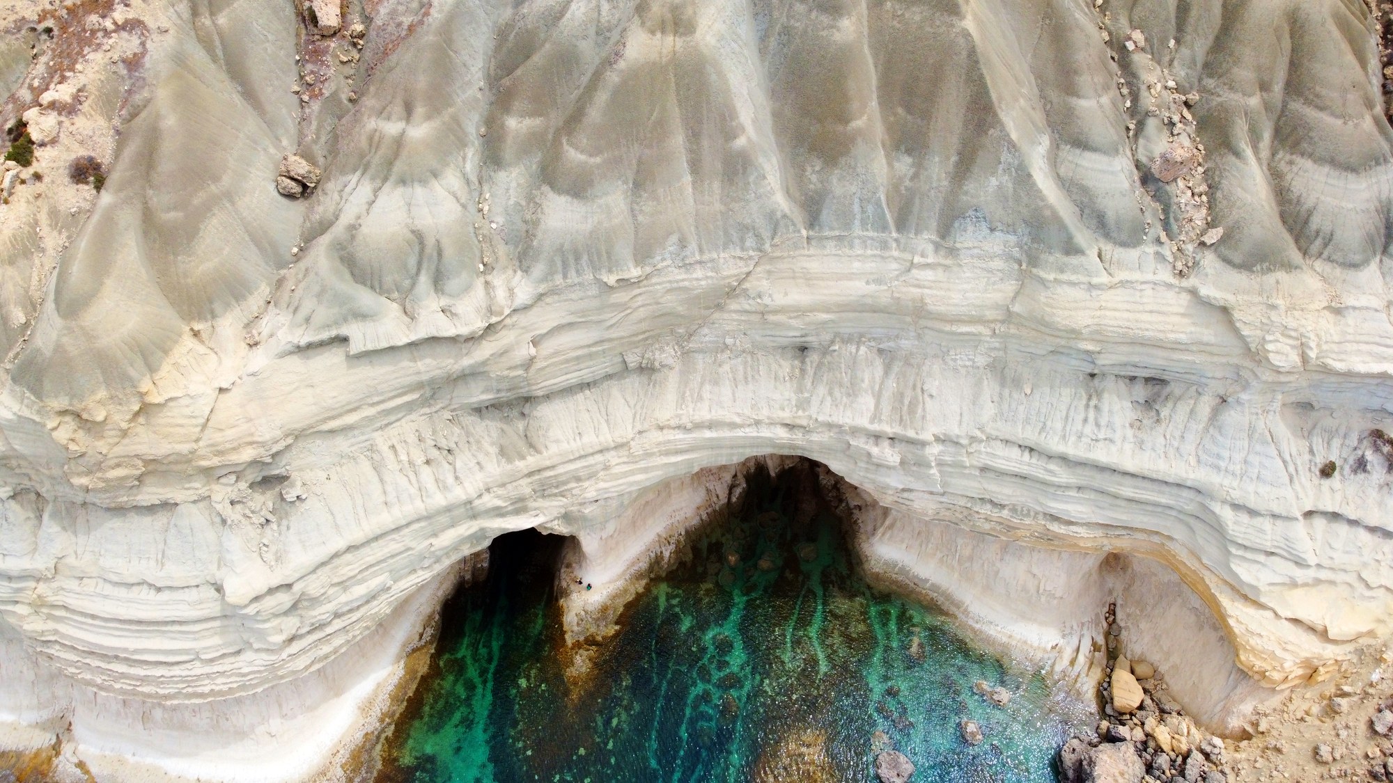 Aerial view into Ta’ Marija Cave and its clear turquoise water